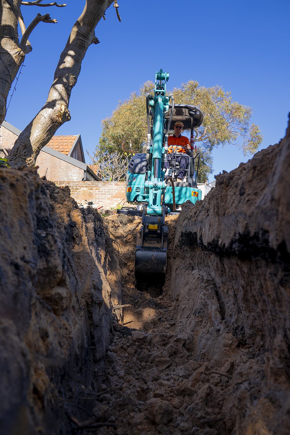 DM Electrical mini excavator trenching for an underground service line